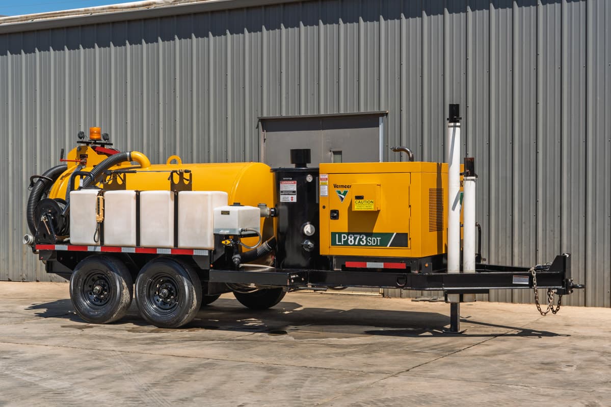 2025 Vermeer LP873SDT trailer-mounted vacuum excavator, 3/4 view, yellow debris tank, water tanks, suction hose, dual-axle trailer