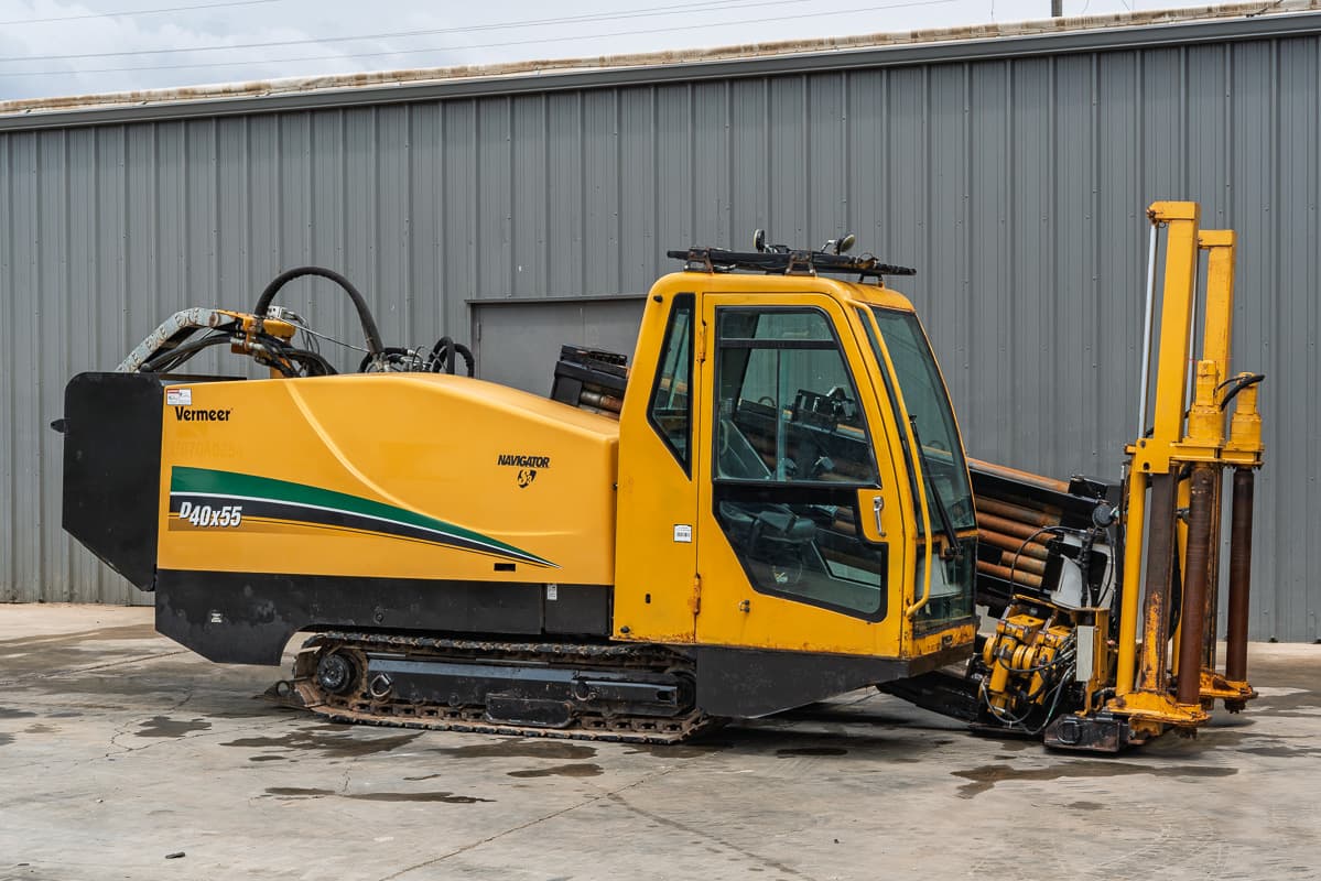 Side view of 2017 Vermeer 40x55 S3 HDD with enclosed cab, steel tracks, and rack of drill pipe in good condition.