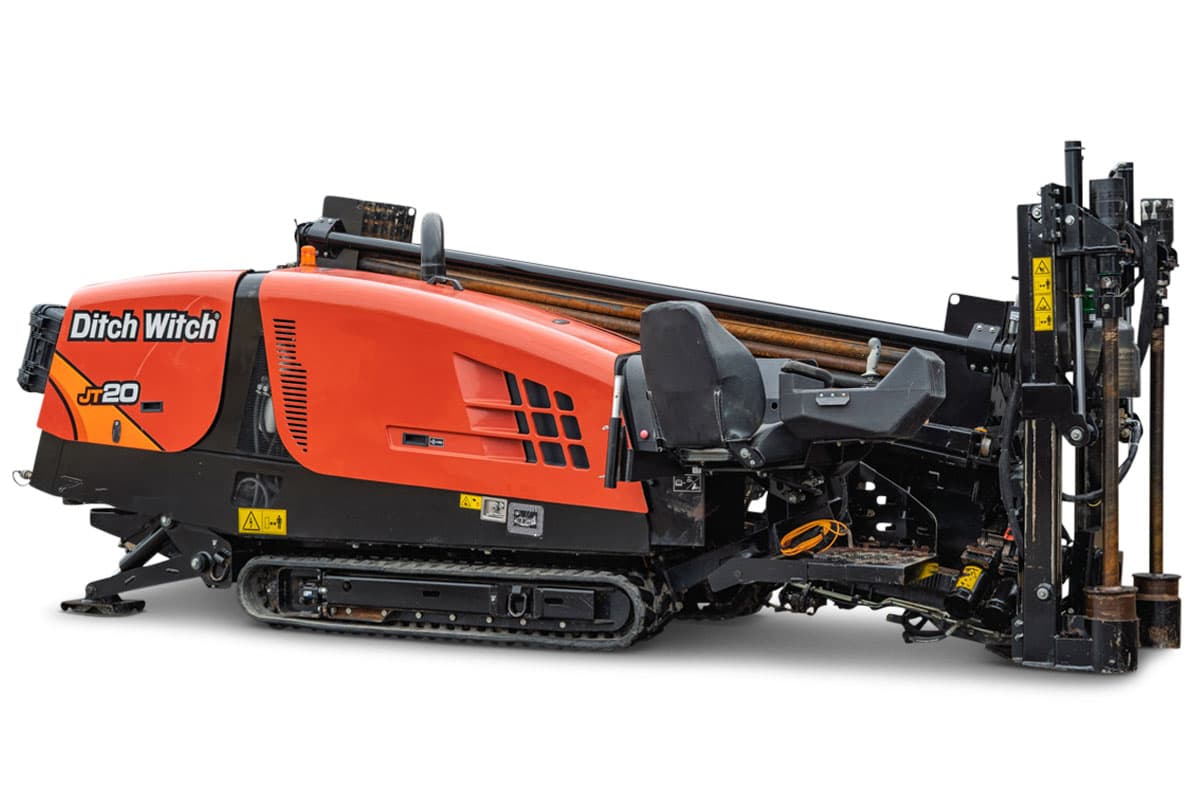 Ditch Witch JT20 HDD rig with red engine compartment, tracked undercarriage, drill pipe rack, and vertical mast assembly, side view