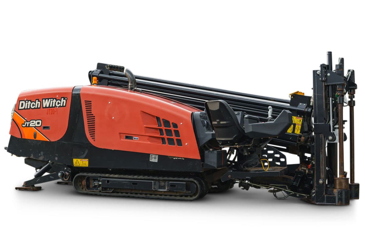 2015 Ditch Witch JT20 HDD drill, 3/4 side view, orange cab, rubber tracks, loaded drill pipe rack, pipe loader carriage visible
