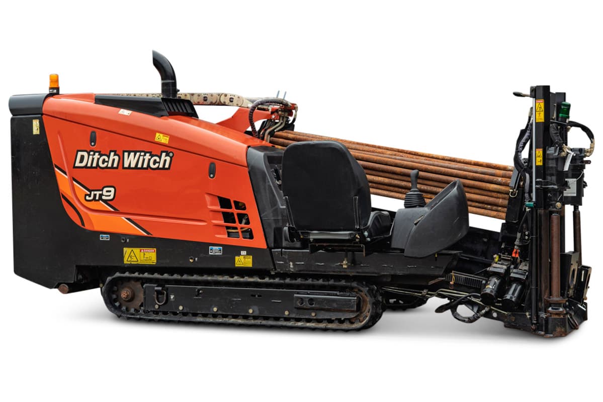 2016 Ditch Witch JT9 HDD drill, 3/4 profile, orange hood, rubber tracks, loaded drill pipe rack, operator seat, carriage assembly visible
