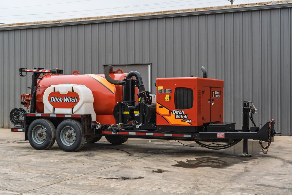2019 Ditch Witch HX30 vacuum excavator, side profile, showing spoil tank, water tank, engine housing, and tandem axle.