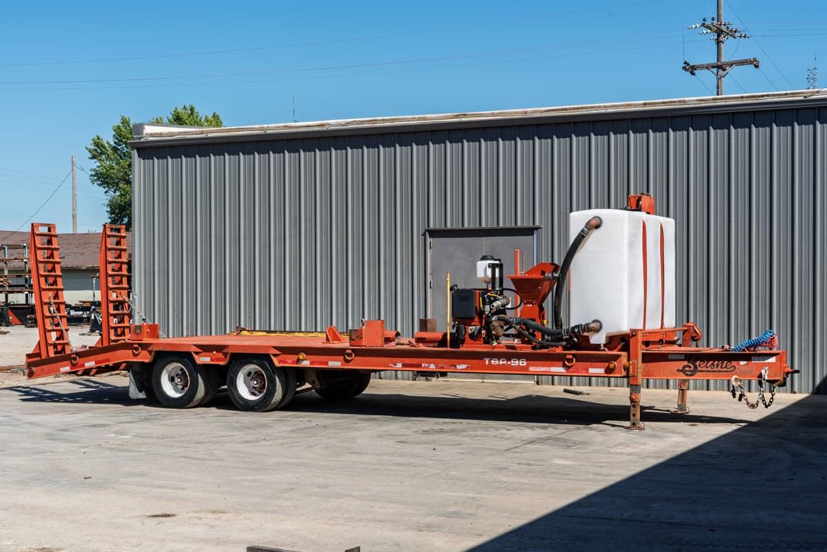 2020 Belshe T10 mud mixing system on red tandem-axle trailer, white poly tank, hopper, pump assembly, fold-down ramps