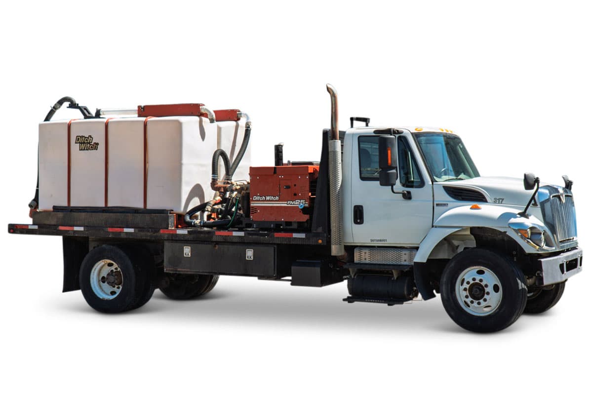 2015 International 7400 mud truck, driver-side view, Ditch Witch FM25 mixing unit, large white poly tank, flatbed, toolboxes, exhaust stack