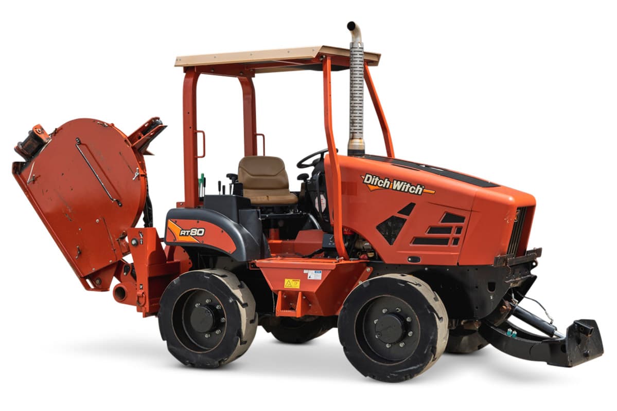 2017 Ditch Witch RT80 quad-wheel trencher with rear attachment, canopy, and clean engine hood, isolated on white background.