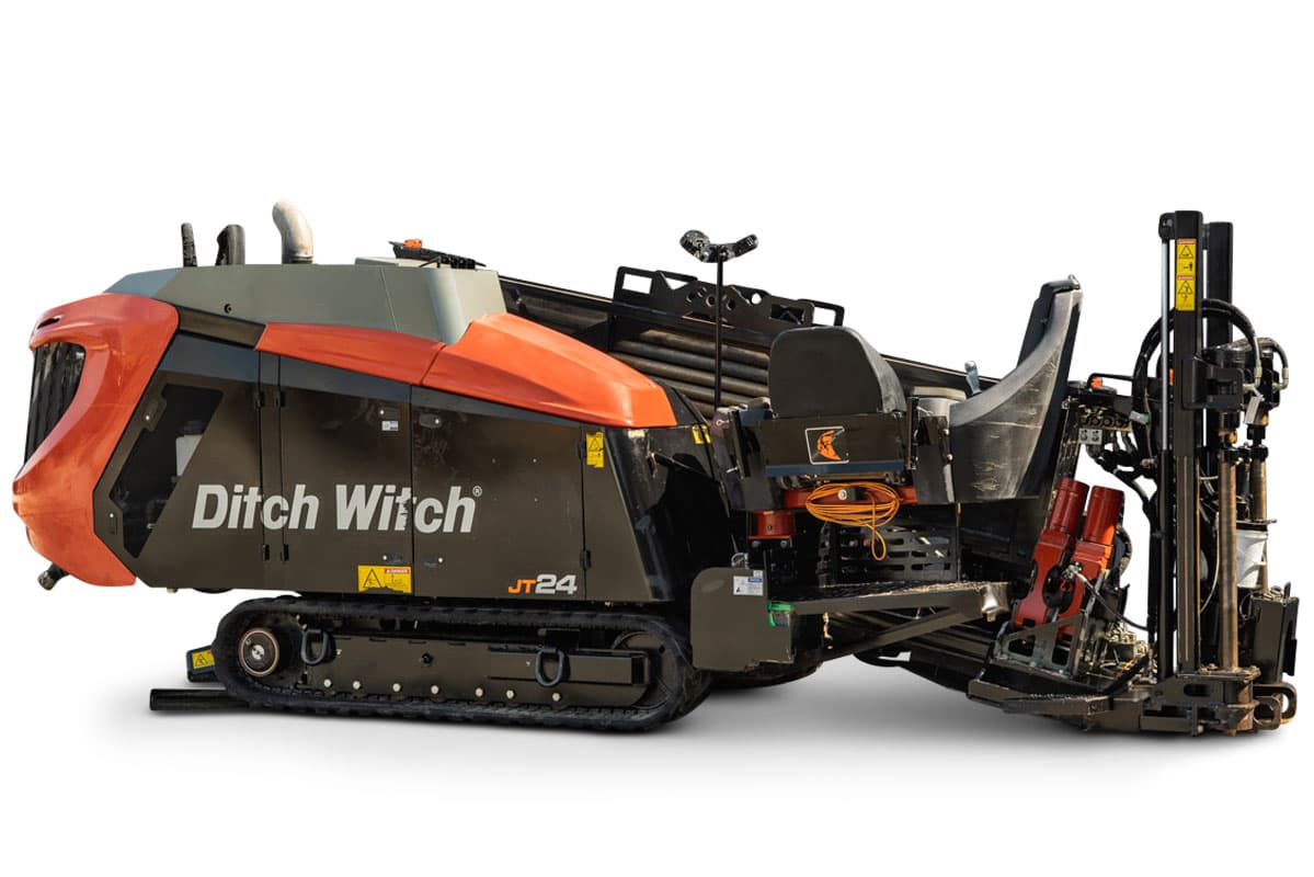 2020 Ditch Witch JT24 HDD drill, 3/4 side view, rubber tracks, loaded drill pipe rack, operator seat, drill frame with vise assembly visible