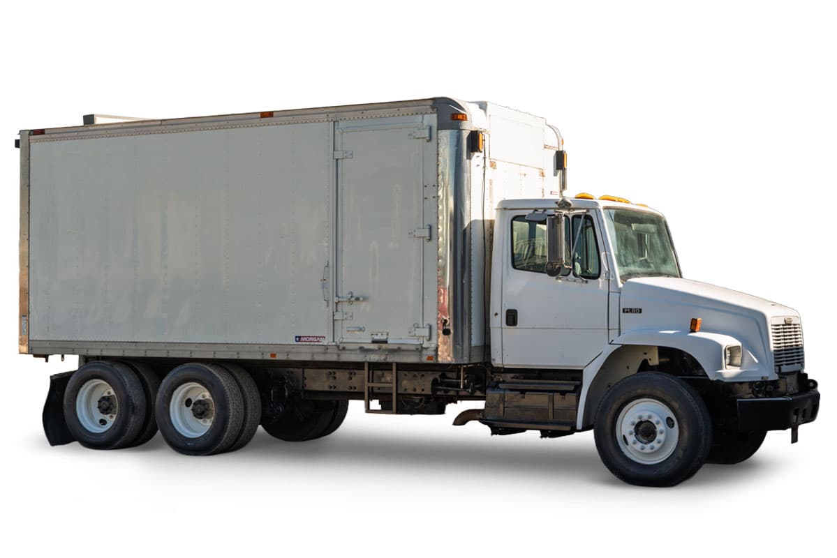 2000 Freightliner FL80 mud truck, side profile view, white cab, tandem axle chassis, and enclosed Morgan box body.