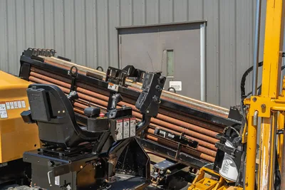 2020 Vermeer D24x40 S3 drill frame close-up showing loaded pipe rack, operator seat, joystick controls, and vise assembly