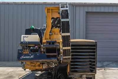 Vermeer D36x50 Series II rear view showing hydraulic control panel, drill carriage, hose track, and engine cooling shroud.