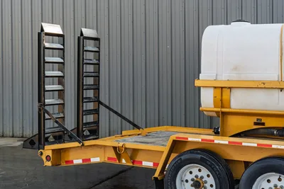 2021 TowMaster T-20D yellow equipment trailer, deployed fold-down ramps, white poly water tank, dual axle, reflective markers