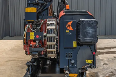 2023 Ditch Witch JT20 HDD drill rear view showing pipe loader carousel, hydraulic lines, engine compartment, and Ditch Witch logo decal