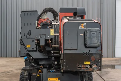 2016 Ditch Witch JT25 HDD drill, rear view showing vise assembly, hydraulic lines, engine compartment, Ditch Witch logo, and rubber tracks
