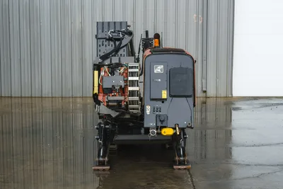 2015 Ditch Witch JT20 HDD drill, rear view showing carriage assembly, hydraulic components, anchor legs, and engine compartment with Ditch Witch badging.