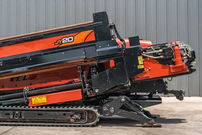 2017 Ditch Witch JT20 HDD rig, side angle showing elevated drill frame, hydraulic carriage, drill pipe, rubber tracks, and anchor system.