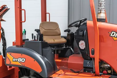 Side view of 2017 Ditch Witch RT80 operator station, featuring steering wheel, control levers, and vinyl seat in cab area.