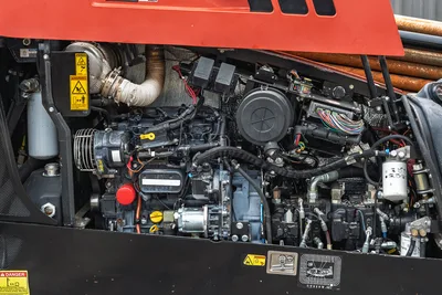 Side view of 2018 Ditch Witch JT20 engine compartment showing clean injectors, filters, hoses, and wiring harness.