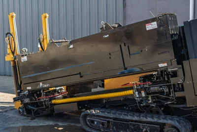 2016 Vermeer D23x30 S3 HDD drill side view showing rubber tracks, thrust frame, hydraulic cylinders, and yellow drill pipe carriage