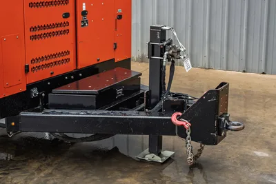 2021 Ditch Witch HX50 mud recycler trailer hitch assembly with tongue jack, safety chain, hydraulic lines, and toolbox; red louvered enclosure visible
