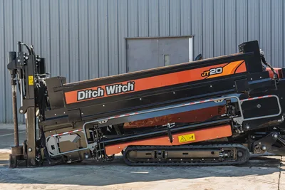 Side profile of 2023 Ditch Witch JT20 HDD drill, showing tracks, drill rod carriage, and engine housing in excellent condition.