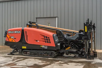 2018 Ditch Witch JT20 HDD drill, side profile view, tracks, operator station, drill pipe rack, and engine cowling visible.