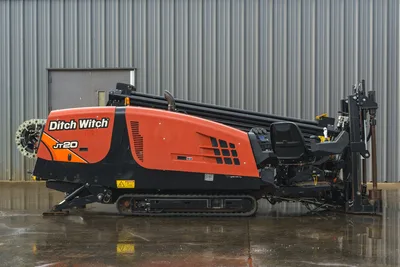 2015 Ditch Witch JT20 HDD drill, full side profile, orange hood, loaded drill pipe rack, pipe carousel, rubber tracks, operator seat visible