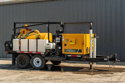 2024 Vermeer LP573SGT vacuum excavator trailer, side profile view showing spoil tank, water tanks, and engine compartment.