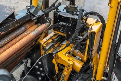 2018 Vermeer D8x12 drill carriage and vise assembly, overhead view, with used 1.66" drill pipe loaded in carousel