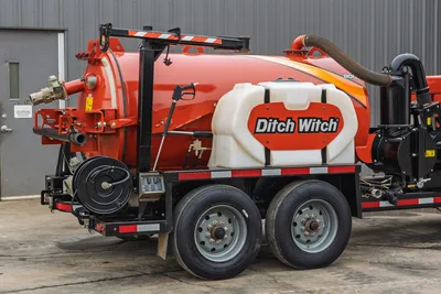 2019 Ditch Witch HX30 vacuum excavator, side view showing dual-axle trailer, spoil tank, water tank, and suction hose.