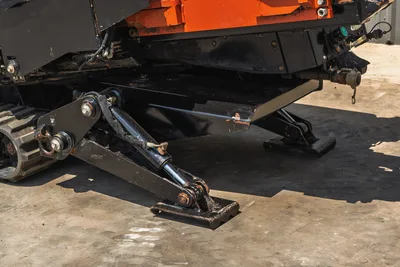 2021 Ditch Witch JT20 hydraulic anchor stake system close-up, deployed ground anchor with cylinder, rubber track visible