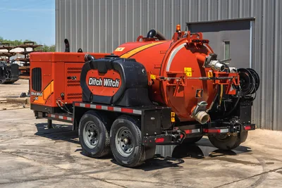 2023 Ditch Witch HX30 vacuum excavator trailer, rear 3/4 view, orange debris tank, hose reel, dual-axle trailer, engine compartment visible