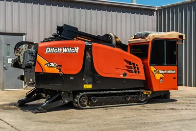 Side profile of a 2016 Ditch Witch JT30 All Terrain HDD rig, showing tracked undercarriage, enclosed cab, and drill pipe.