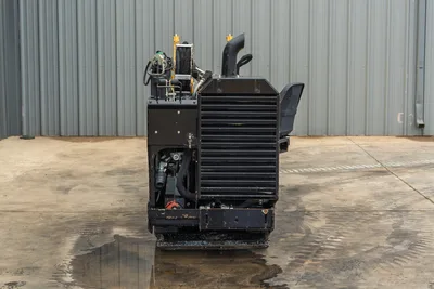 2018 Vermeer D8x12 HDD drill, rear view showing louvered engine compartment, exhaust stack, hydraulic lines, and operator seat