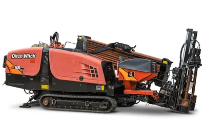 2021 Ditch Witch JT28 HDD drill, side view, rubber tracks, loaded drill pipe rack, thrust frame, vise assembly visible