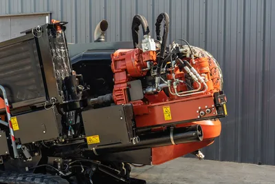 2020 Ditch Witch JT24 directional drill carriage, rotation motor, and hydraulic plumbing detail; side-profile close-up view.