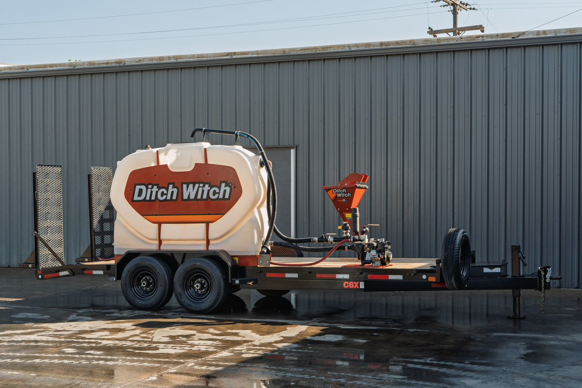 2023 MAXX-D C6X tandem-axle mud trailer, Ditch Witch water tank, bentonite mixer, pump assembly, flatbed deck, side profile view.