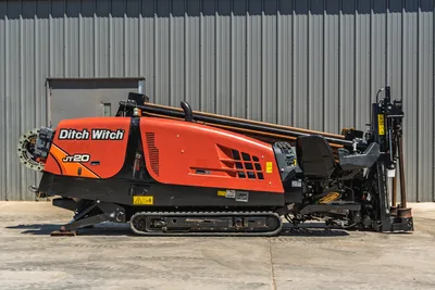 2021 Ditch Witch JT20 horizontal directional drill, side view, showing tracks, operator station, and drill pipe rack.