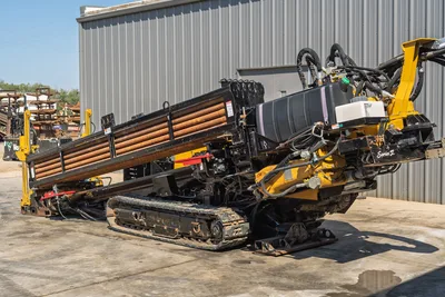Rear-angle view of used Vermeer D36x50 Series II HDD rig featuring drill pipe rack, steel tracks, and hydraulic mechanics.