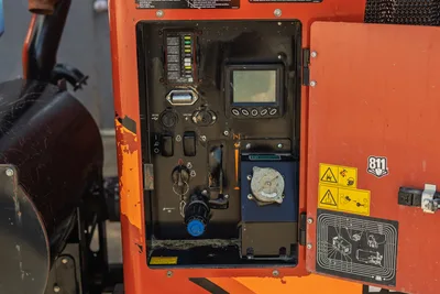 2022 Ditch Witch HX30 mud mixer control panel with fuse block, LCD display, ignition, toggles, and fuel cap; worn orange housing