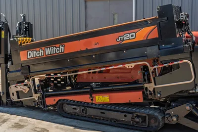 Side profile of 2018 Ditch Witch JT20 HDD featuring drill pipe rack, rubber tracks, and side engine compartment housing.