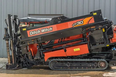 2017 Ditch Witch JT30 HDD drill, drill frame angled up, rubber tracks, drill pipe loaded, hydraulic components visible
