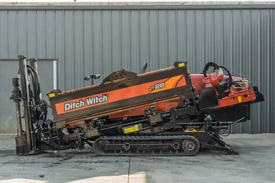 2021 Ditch Witch JT28 HDD drill, side profile, angled drill frame, rubber tracks, vise assembly, hydraulic rotary head visible