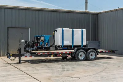 Behnke TBCT2220ET-BT-R HDD mud mixing trailer, side view, white poly tank with blue straps, SL500 mixer, hose reel, tandem axle