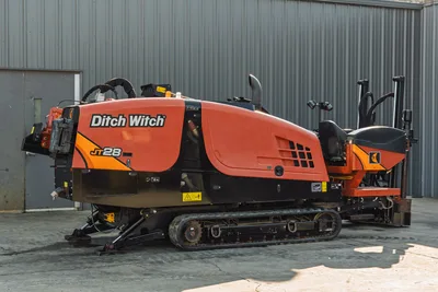 2021 Ditch Witch JT28 HDD drill, 3/4 side view, orange hood with JT28 branding, rubber tracks, operator seat visible