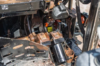 2021 Ditch Witch JT20 carriage drive system close-up showing worn spindle, rack gear, and drill frame components with surface rust