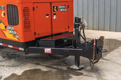 2019 Ditch Witch HX30 vacuum excavator, side profile view of tongue assembly, hydraulic jack, hitch, and engine housing.