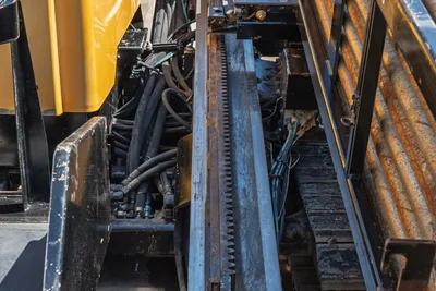 2020 Vermeer D24x40 S3 drill frame rack-and-pinion thrust system, hydraulic hoses, and steel tracks, overhead close-up view