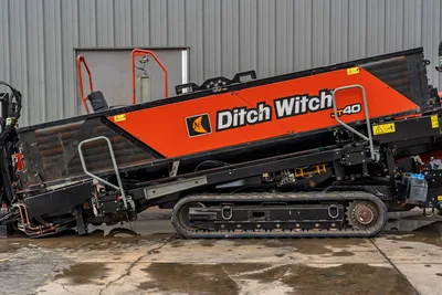 2021 Ditch Witch JT40 HDD drill side profile, orange hood panel, rubber tracks, hydraulic components, drill frame angled upward