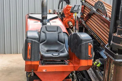 2021 Ditch Witch JT28 operator seat, armrests, dual controls, drill pipe rack loaded with 2.375" pipe, vise assembly visible