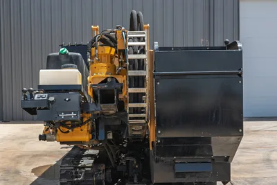 2021 Vermeer D24x40 S3 HDD drill, rear 3/4 view showing vise assembly, pipe rack, hydraulic hoses, rubber tracks, and black drill pipe box
