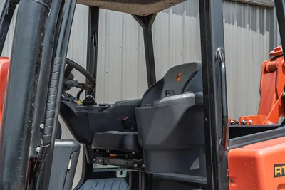 2024 Ditch Witch RT125Q operator station, black suspension seat, steering wheel, ROPS frame, controls; low-hour condition
